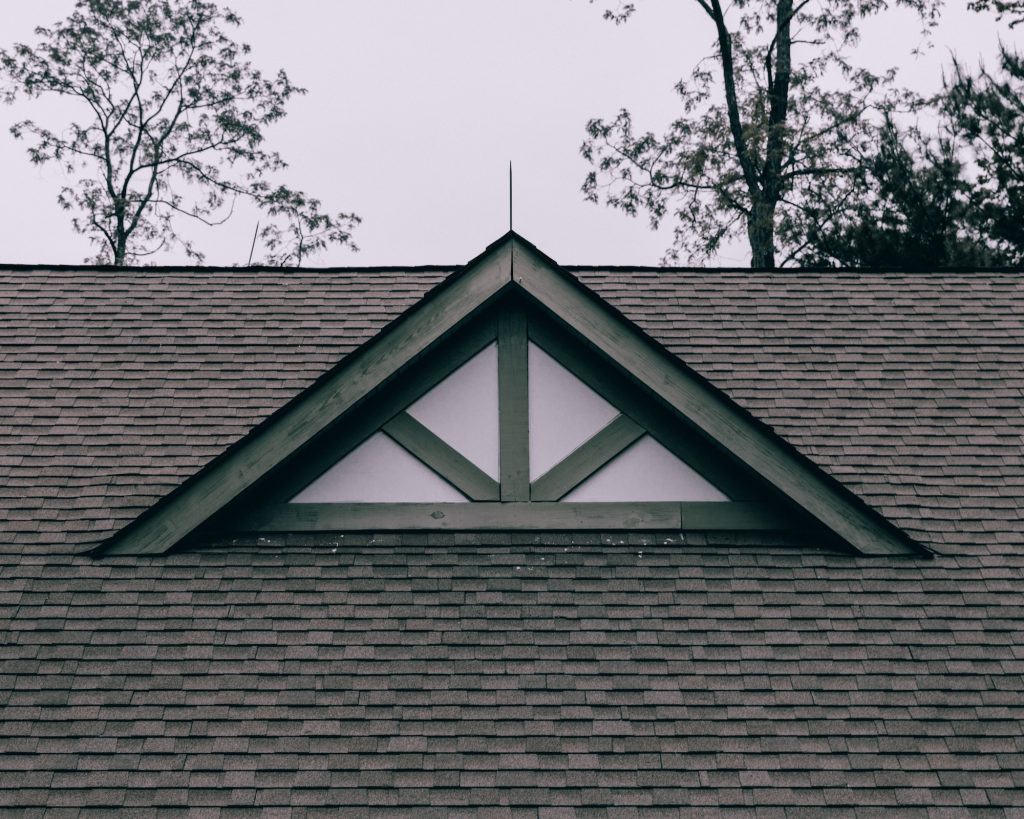 An image of a roof with a triangle on it, showcasing the effects of power washing.