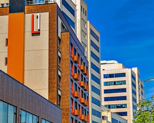 A building with a power washed red and orange facade.