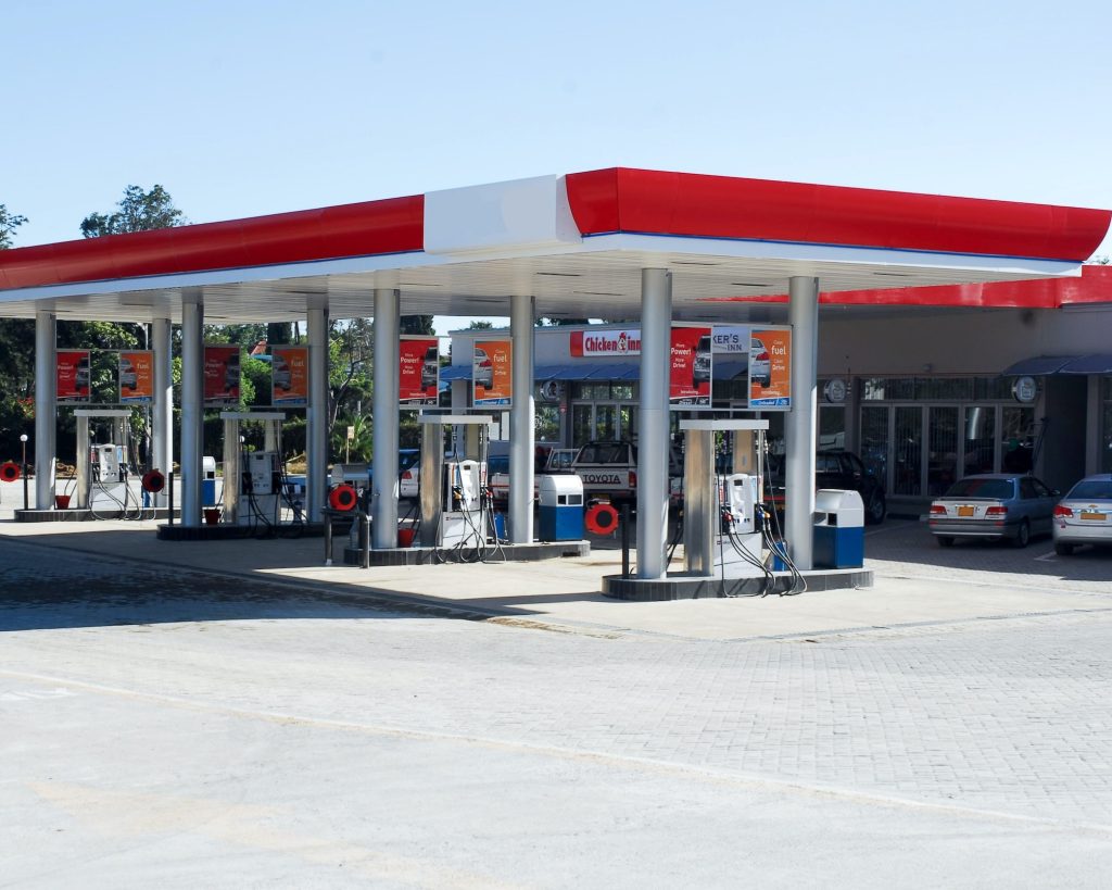 A red and white gas station offering power washing services.